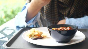 A woman eating a bowl of food video
