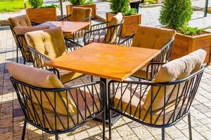 Charming and Cozy Outdoor Cafe Seating, Featuring Cushioned steel Chairs for Ultimate Comfort photo