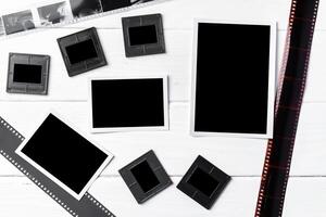 Old vintage film, slides and photos on white wooden background