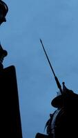 silhouet van een imposant ridder gekleed in schild reeks tegen een verduistering lucht Bij schemer video