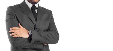 A man in a suit and tie standing with his arms crossed photo