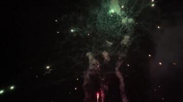Real fireworks background in the night sky. Glowing fireworks show. FullHD footage with sound video