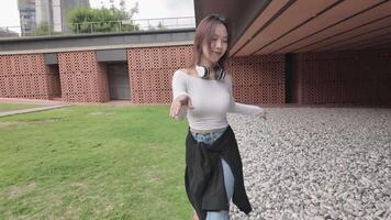 Young Asian woman walking and dancing in the city. Style. Hip hop and freestyle. video
