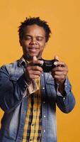 verticale africain américain Jeune femme fabrication sa mari perdre le jeu, sentiment content et célébrer sa en ligne jeu tournoi gagner. joyeux détendu marié couple en jouant concours. caméra b. video