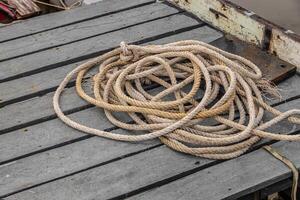 Boat rope, Mooring Line heavy duty old grunge used weathered for secure parking the boat at pier dock. photo