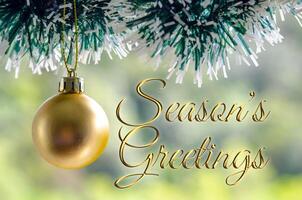 Seasons Greetings wishes with golden Christmas ball background. Christmas celebration concept photo