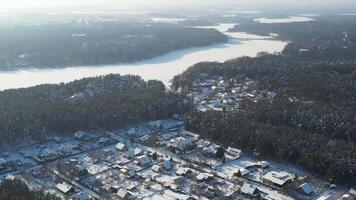 Top view of the winter village in the forest in Zhdanovichi. Belarus. Minsk. Beautiful winter landscape with forest houses video