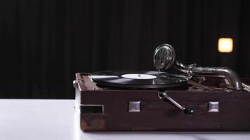 Old gramophone playing a vinyl record in a dark room video