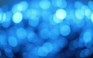 Vibrant blue bokeh lights create a dreamy atmosphere during an evening celebration in a lively urban setting photo