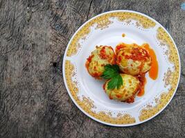 Egg Balado. Balado is a type of hot and spicy bumbu spice mixture found in Indonesian cuisine. Balado sauce is made by stir frying ground red hot chili pepper with other spices photo