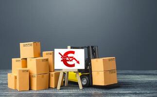 Forklift near boxes and easel red euro symbol down arrow. Price reduction. Low competitiveness of goods. Decline in production, low sales due to adverse bad economic trends shocks and disasters. photo