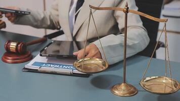 Lawyer holding scales of justice in court video