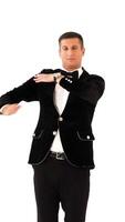 funny man in a black suit and white shirt is dancing macarena on the background of white studio. Parody of the popular dance. Macarena Vertical video