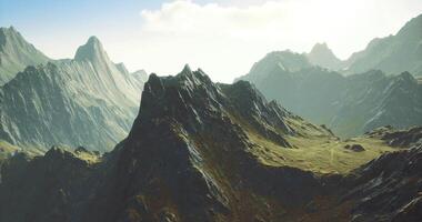 majestuoso montaña paisaje con escabroso terreno y luz de sol en el antecedentes video