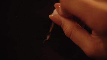 Hand drawing a chalk line on a blackboard video
