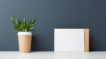 A white card with a brown border sits on a table next to a potted plant photo