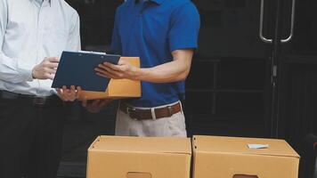 Two men are holding a clipboard and a box video