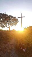 portrait of a large cross with a sunset background video