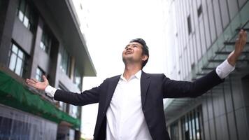 A young Asian entrepreneur radiates confidence and pride, his face glowing with the satisfaction of achieving success after years of hard work and dedication. video