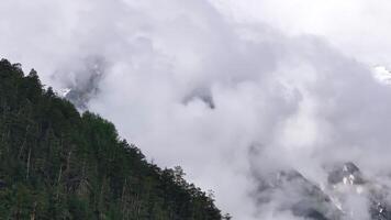 Clouds passing over snowy mountain peaks video