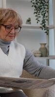 ouderen vrouw lezing een krant- Bij huis Aan de bankstel video