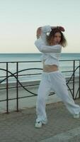 Young Woman In White Clothes Dances Rap On The Street Near The Sea In Italy video