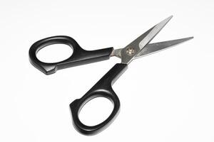 scissors with a black handle on a white background photo