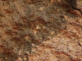 A close up of a rock wall with brown and black paint video