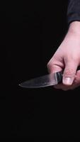 Criminal hand holding knife in threatening posture video