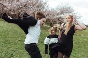 Three girls in black and white running in the grass photo
