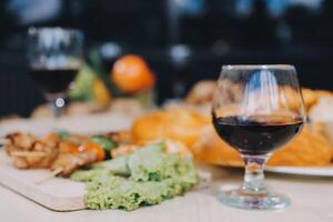 A glass of wine and a plate of food photo