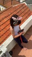 A group of young people enjoying a sunny day on the rooftop while using their phones video