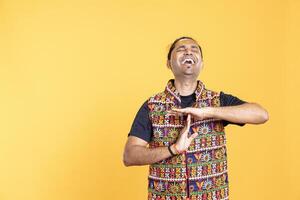 Portrait of happy man laughing too hard, asking for timeout after running out of breath. Amused cheerful person doing pause sign gesturing, wishing for break, having too much fun, studio background photo