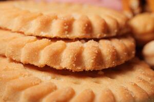 Delicious cookies stacked on a wooden table after baking photo